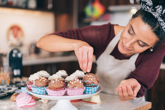 Confectioner decorating Chocolate Cupcakes