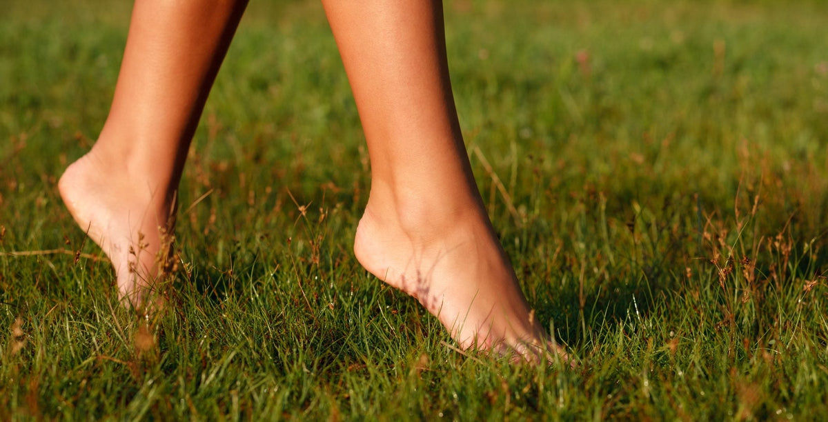A person going barefoot in the grass