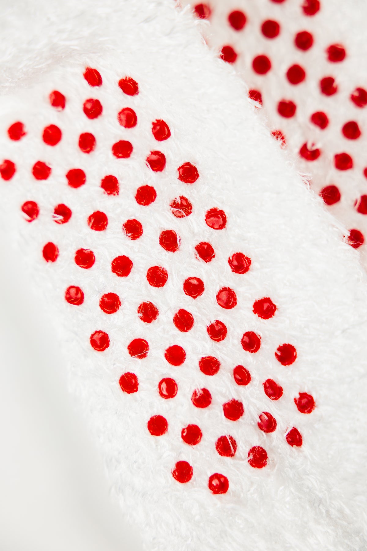 Baby Foot white plush socks, exfoliating foot peel for kids, designed to soften and smooth skin on feet.