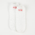 Baby Foot white plush socks for exfoliating foot peel, featuring soft, plush material and designed for foot skincare.