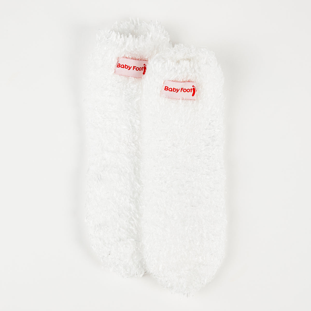 Baby Foot white plush socks for exfoliating foot peel, featuring soft, plush material and designed for foot skincare.