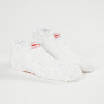 Baby Foot White Plush Socks for exfoliating foot peel, soft plush material designed for gentle foot exfoliation and skincare.