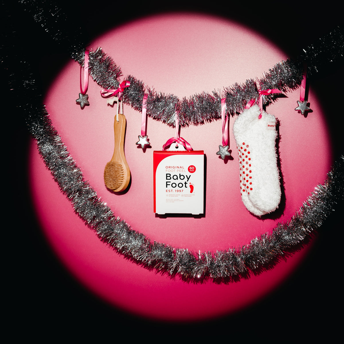 Baby Foot exfoliating foot peel from The Foot Care Essentials Bundle, showing the product packaging and application process.